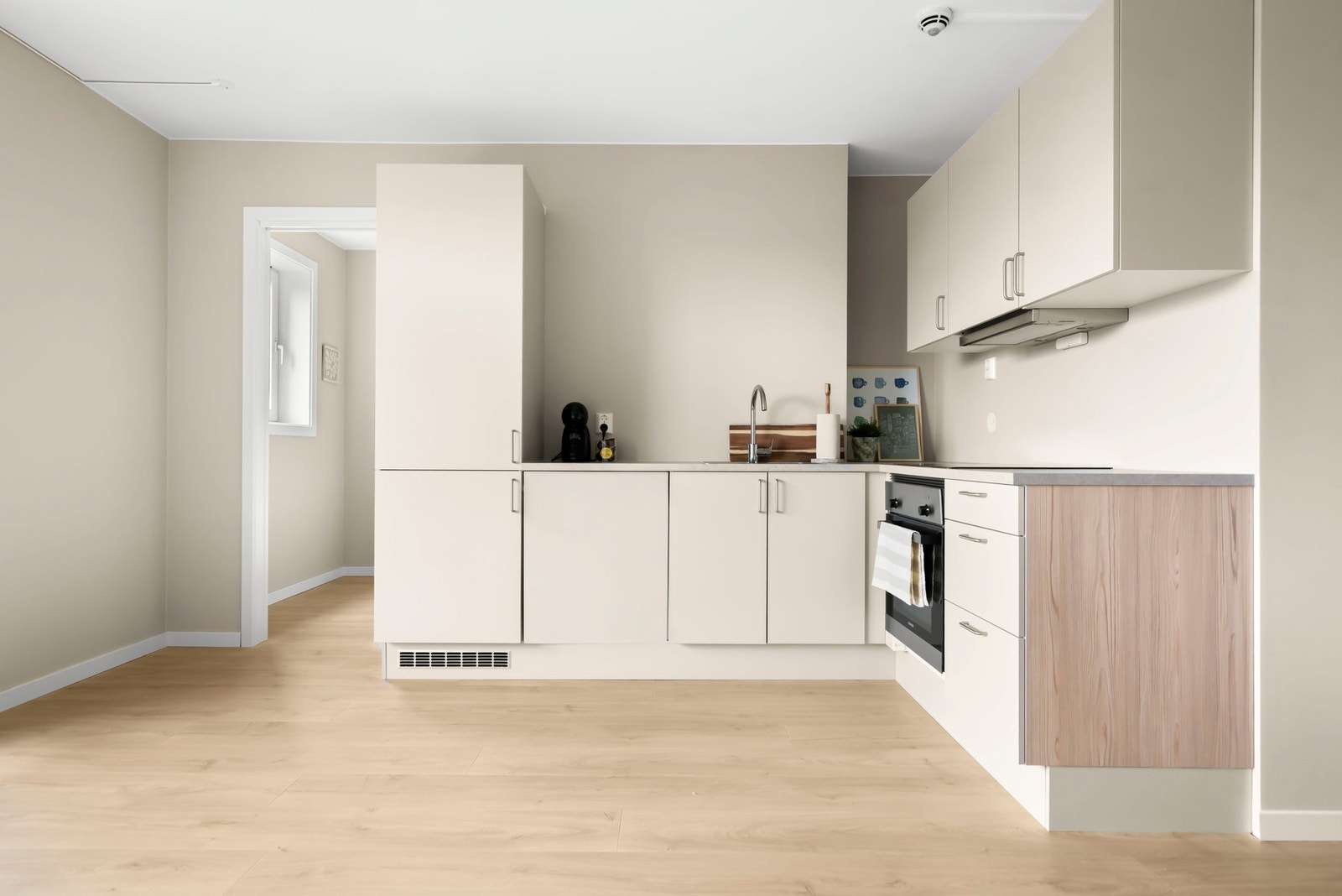 Moderne og tidløs kjøkkeninnredning fra 2024 med glatte, folierte fronter og slitesterk benkeplate i laminat. Galleribilde