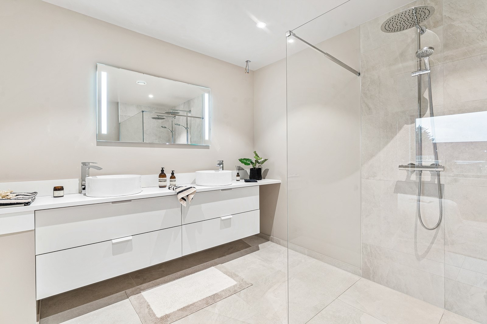 Lys og moderne baderomsløsning med romslig dusj, doble servanter og stilrent design som gir en følelse av luksus Galleribilde