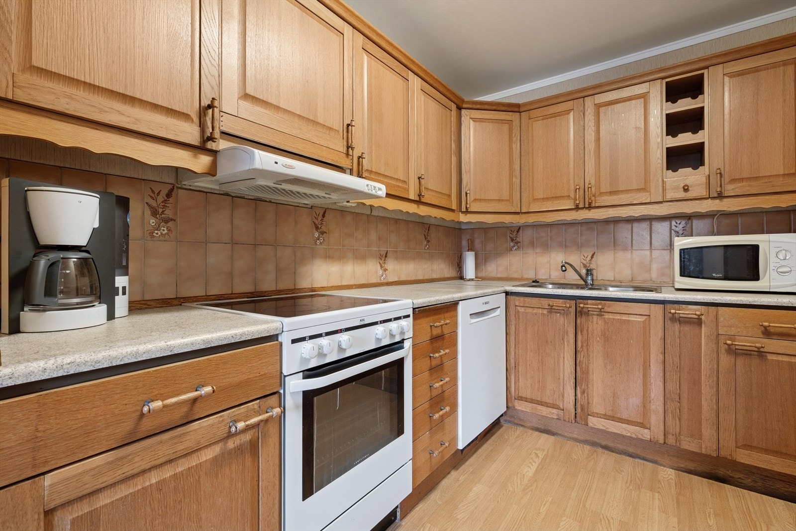 Kjøkken med klassisk innredning med laminerte skrog, profilerte fronter og laminat benkeplate. Galleribilde