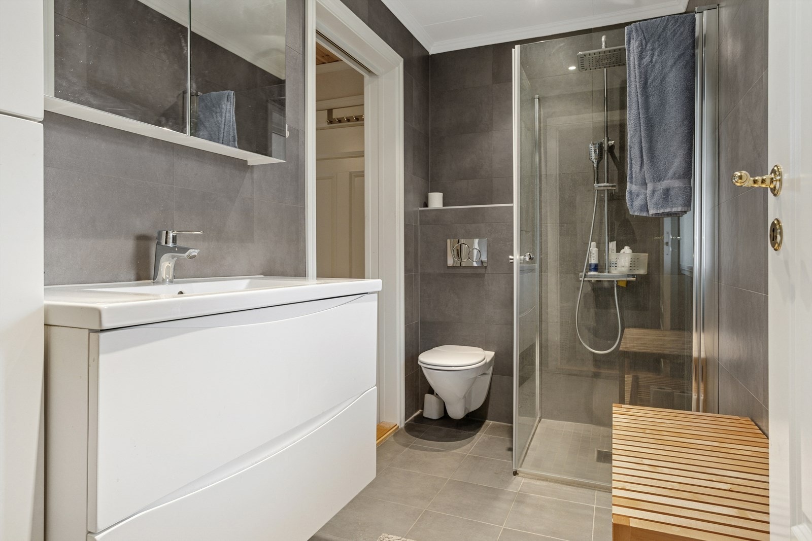 Baderommet inneholder servant med innredning, vegghengt toalett og dusj, samt varmekabler i gulvet. Galleribilde