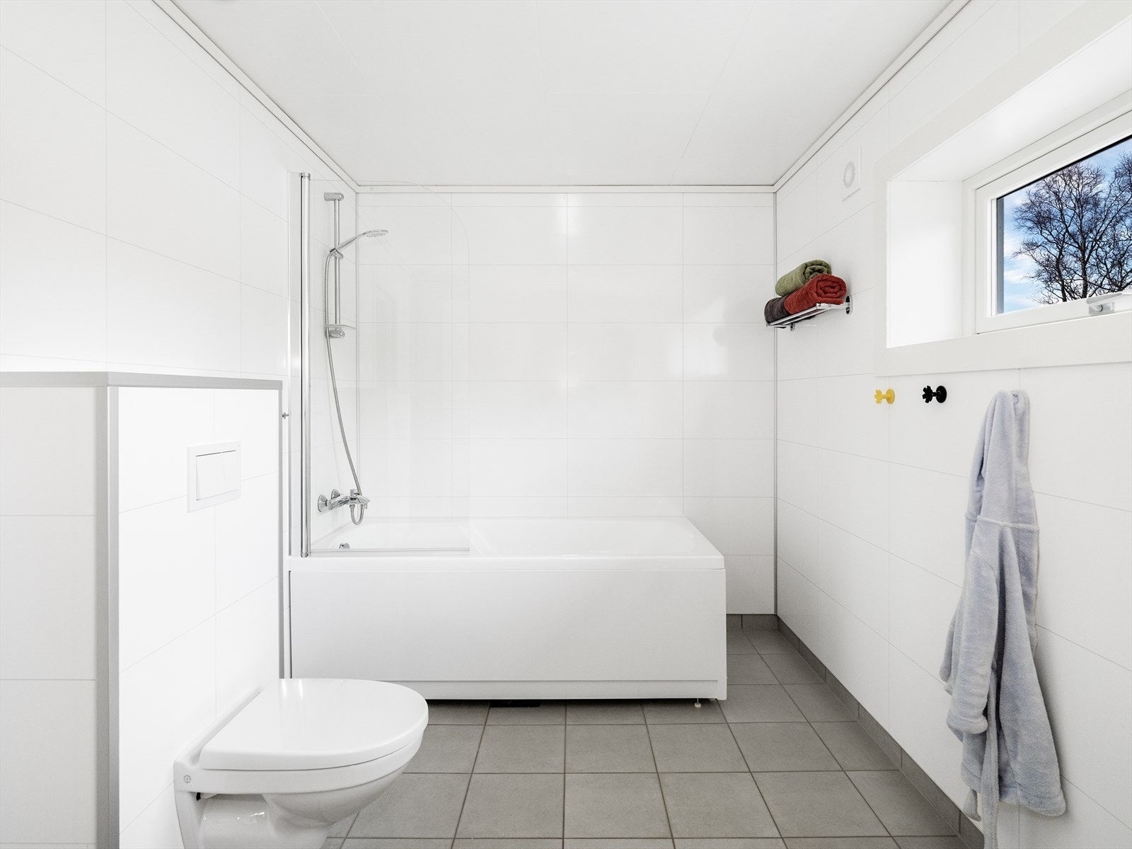 Lyst og moderne baderom med badekar, perfekt for avslappende stunder Galleribilde