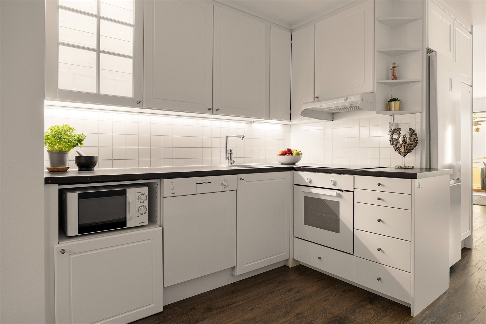 Kjøkkenet består av opplegg for oppvaskmaskin, nisje til kjøle/fryseskap, og integrert platetopp og stekeovn. Galleribilde