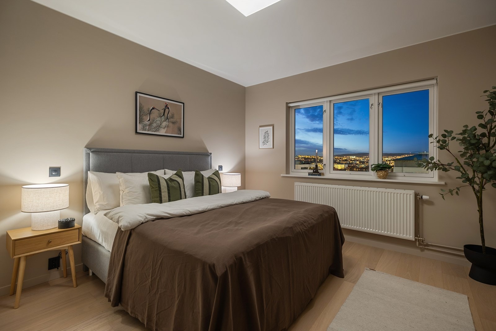 Store vinduer gir utsikt over byen fra hovedsoverommet. Galleribilde