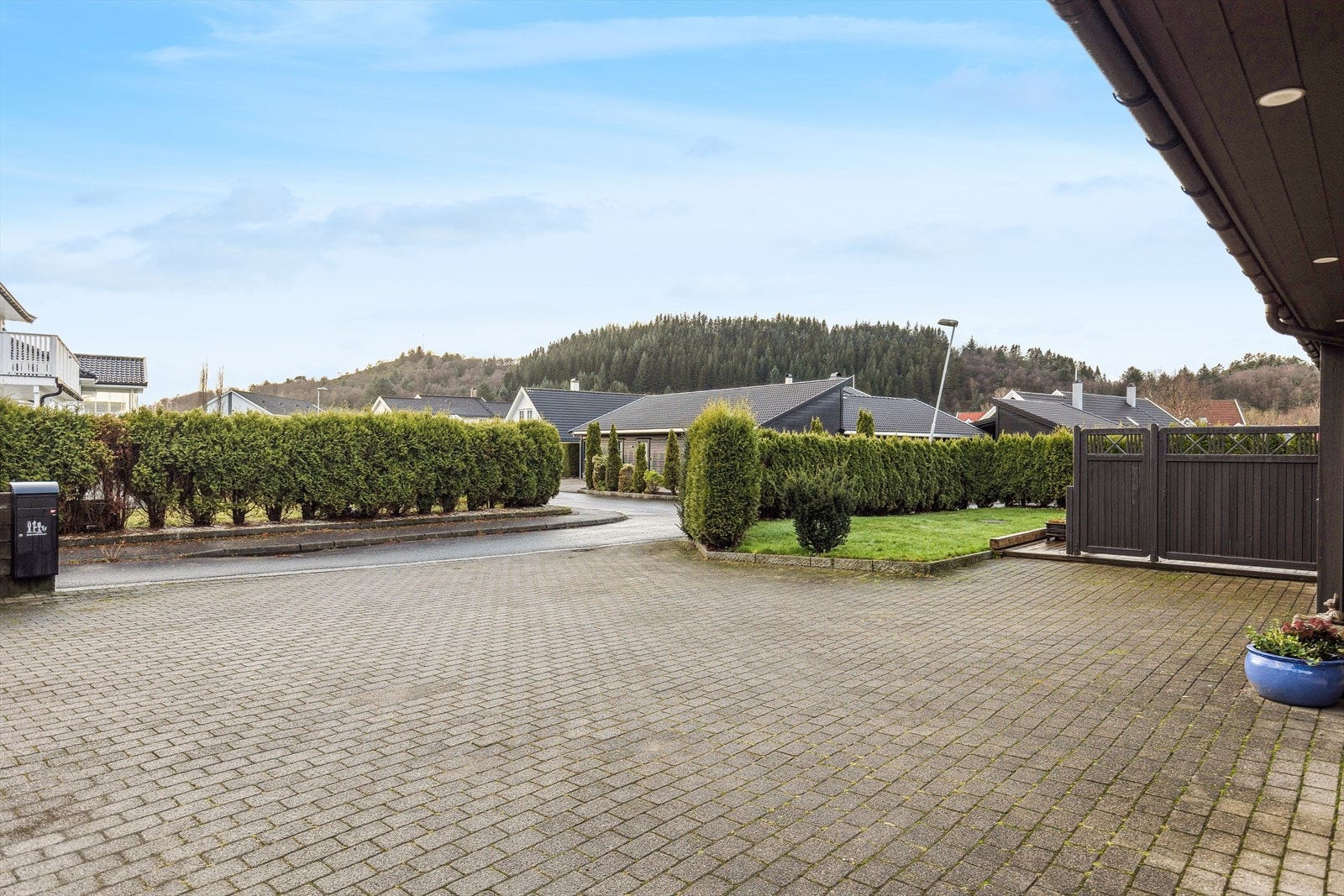 Opparbeidet gårdsrom med belegningsstein gir et pent inntrykk til boligens inngangsparti. Galleribilde