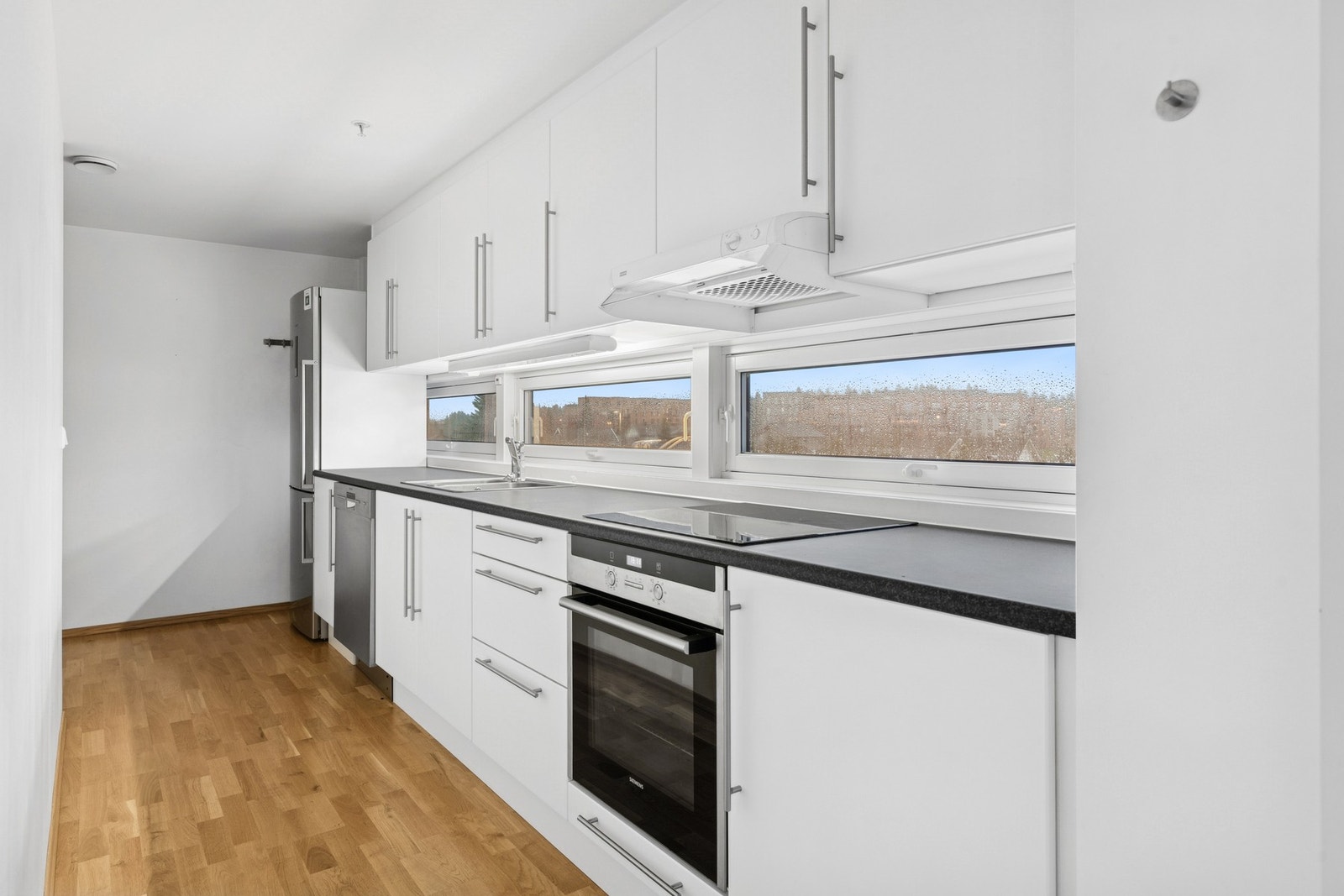 Kjøkkenet har innredning fra Aubo med glatte fronter og delvis integrerte hvitevarer. Galleribilde