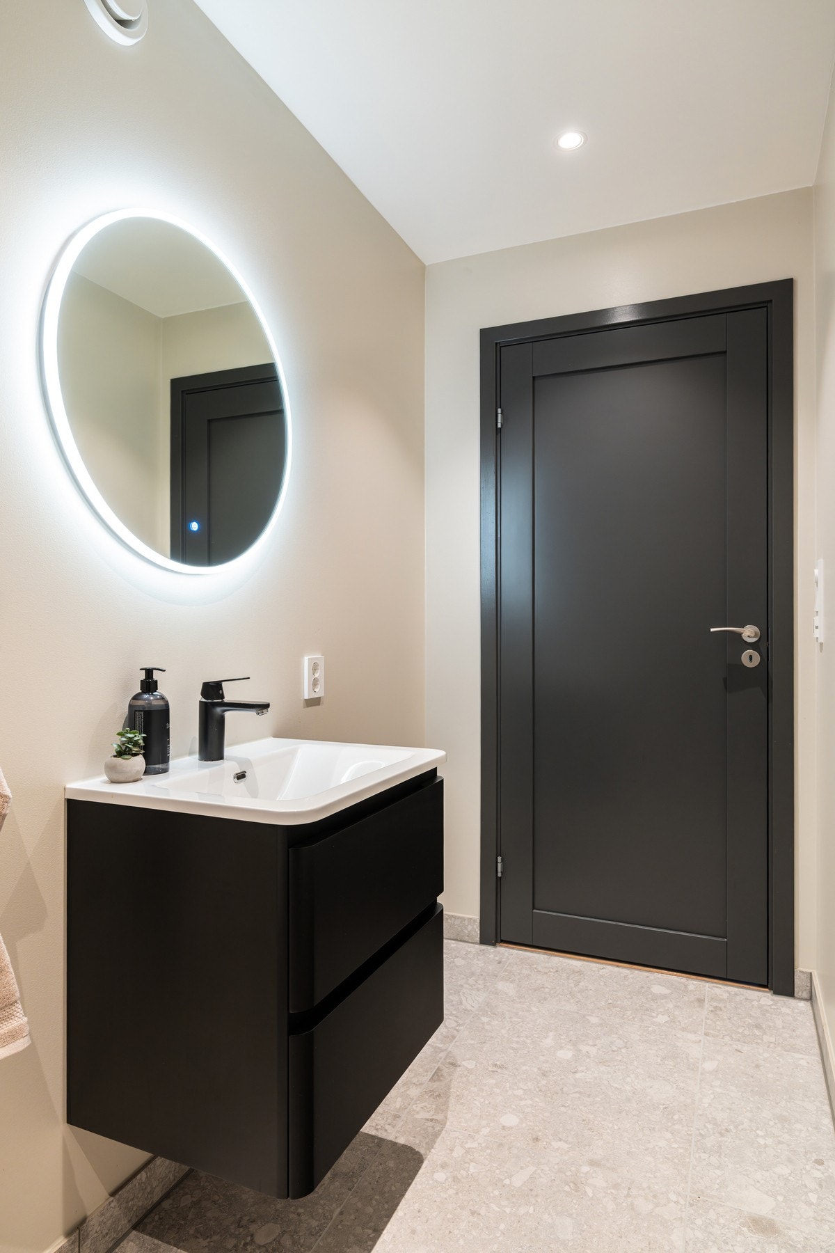 Stilren baderomsinnredning fra Hög Baderom med heldekkende servant og delikat speil med integrert belysning. Galleribilde