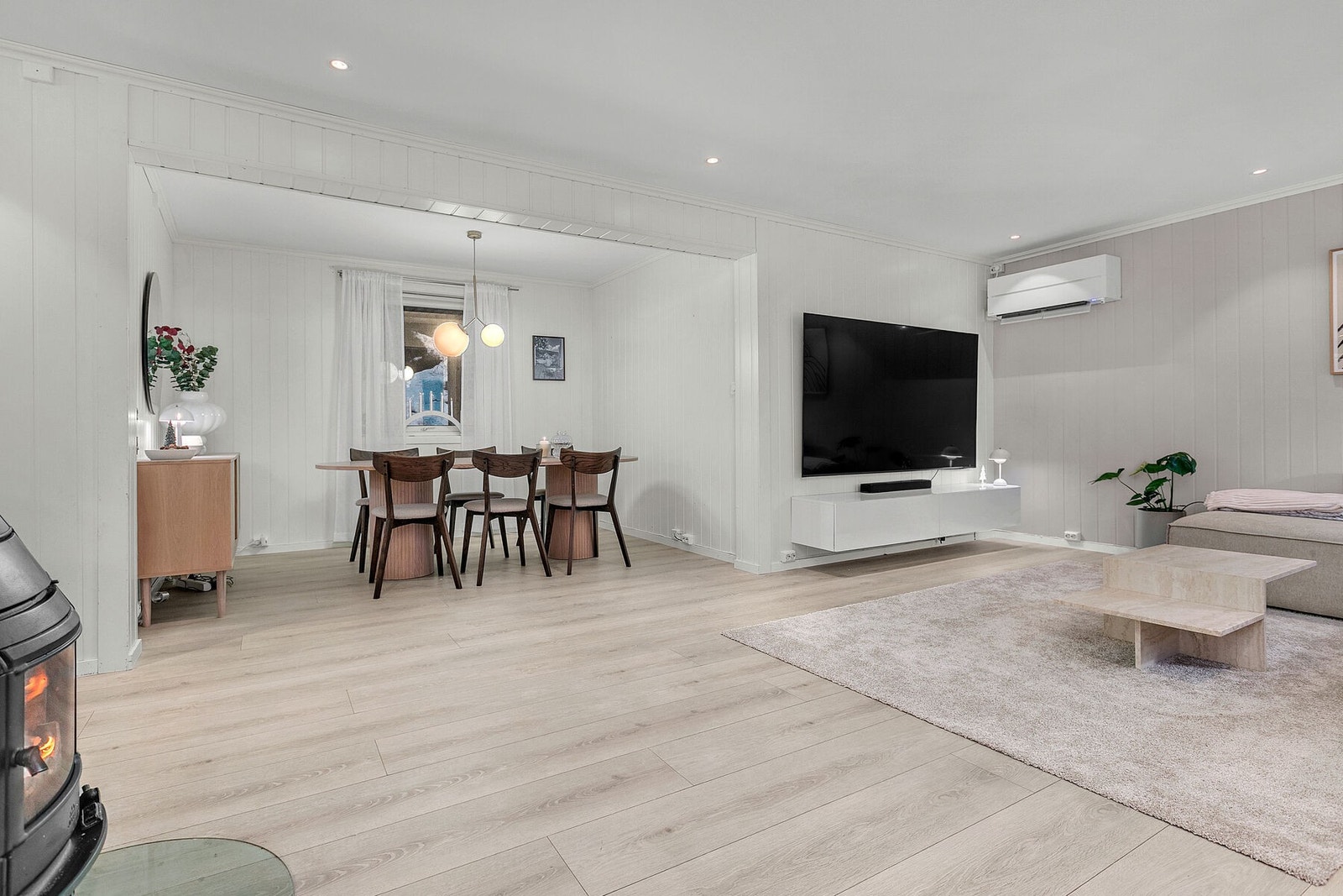 Stuen har pene gulv, spotter i tak, varmepumpe og vedovn Galleribilde