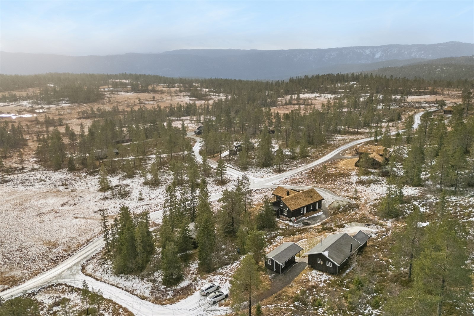 Luftfoto viser eiendommens plassering i et naturskjønt område med god adkomst og nærhet til friluftsliv. Galleribilde