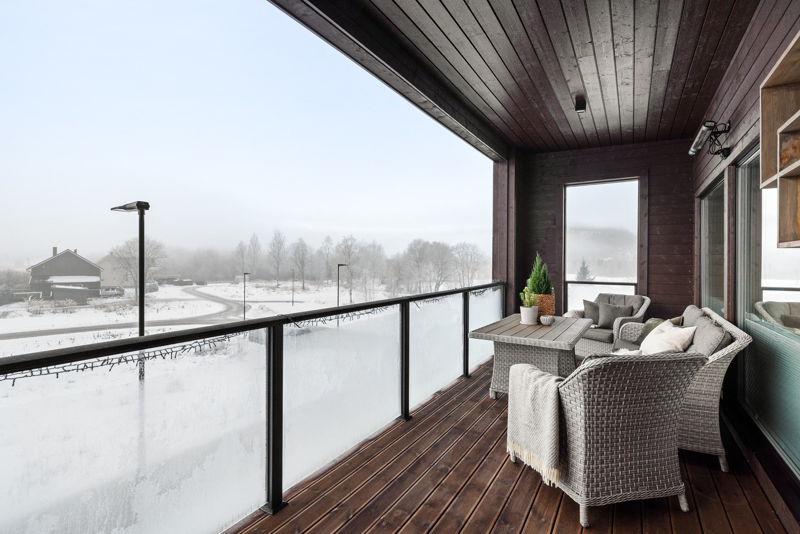 Takoverbygd terrasse belagt med royalimpregnerte terrassebord. Glassrekkverk i front og levegg mot nabo Galleribilde