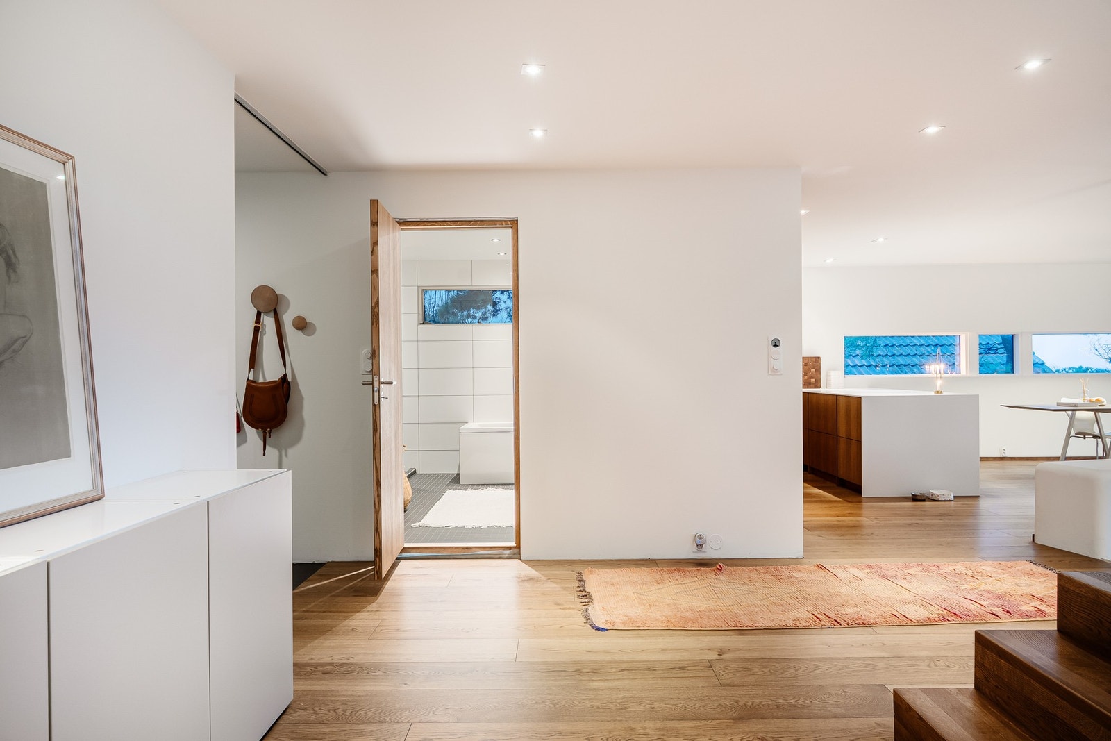Fra hallen og soveromsgangen ut til kjøkken og stue. Hovedbad rett frem og entre til venstre. Galleribilde