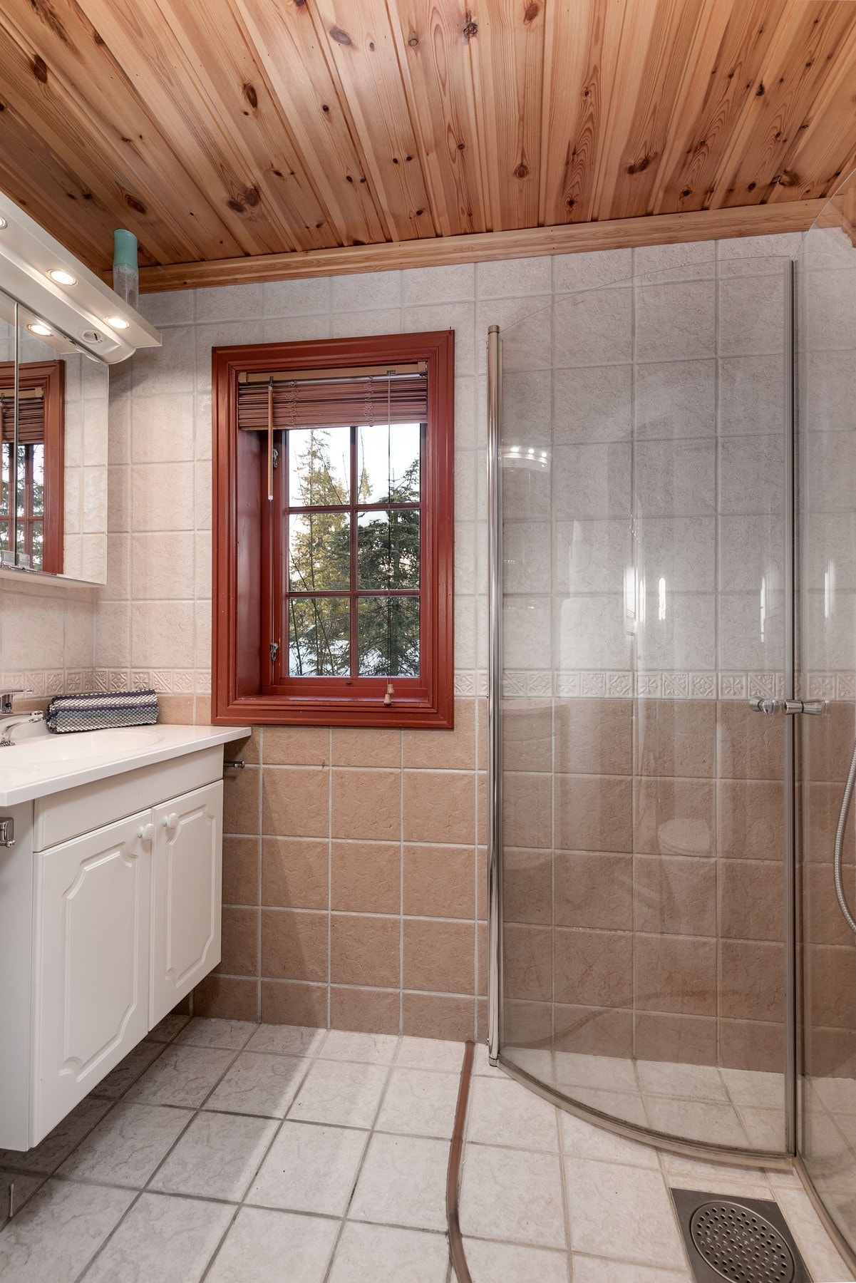 Badet har flislagte overflater på gulv og vegger, samt panel i himling. Galleribilde