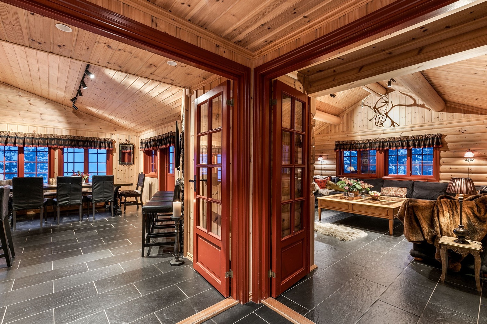 Flotte doble fløydører mellom spisestue/kjøkken og stuen, som harmonerer godt med detaljene i hytta Galleribilde