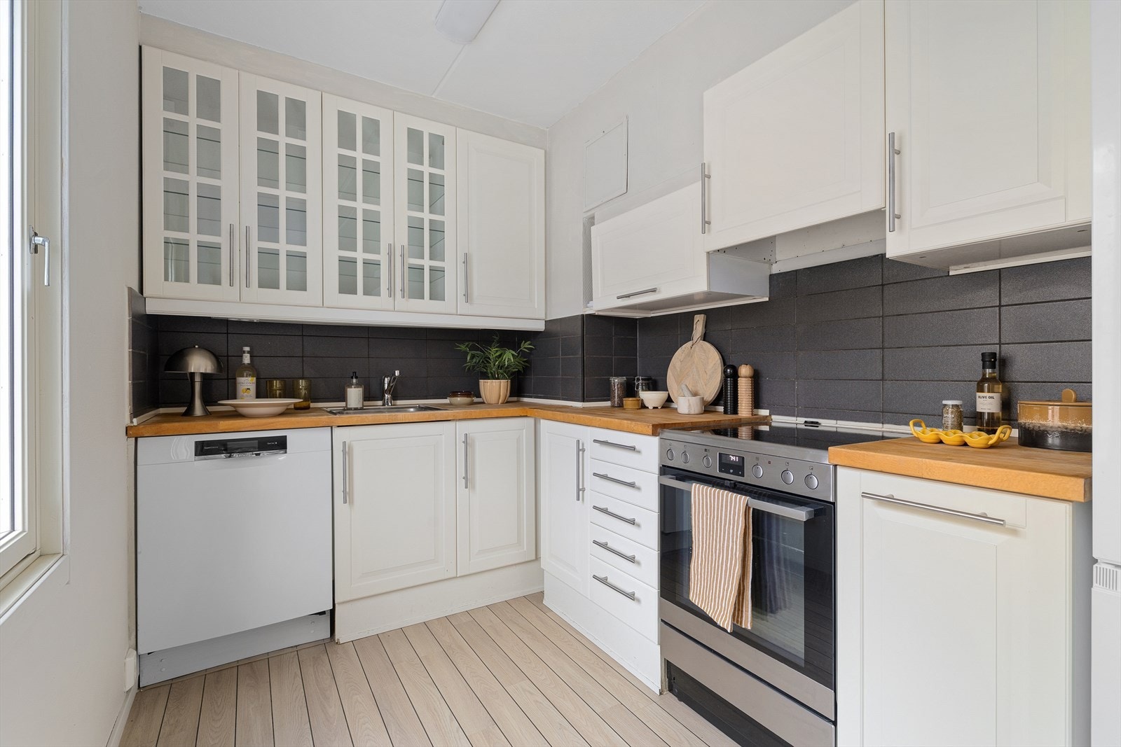 Kjøkkenet har godt med benkplass, hvitevarer og gode lysflater Galleribilde