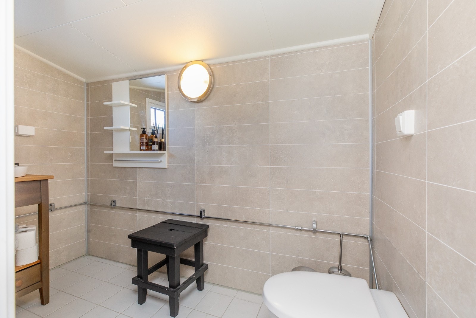 Våtromsplater på vegg og flislagt gulv med gulvvarme. Dusjnisje med forheng, Jets-vakumtoalett og servant Galleribilde