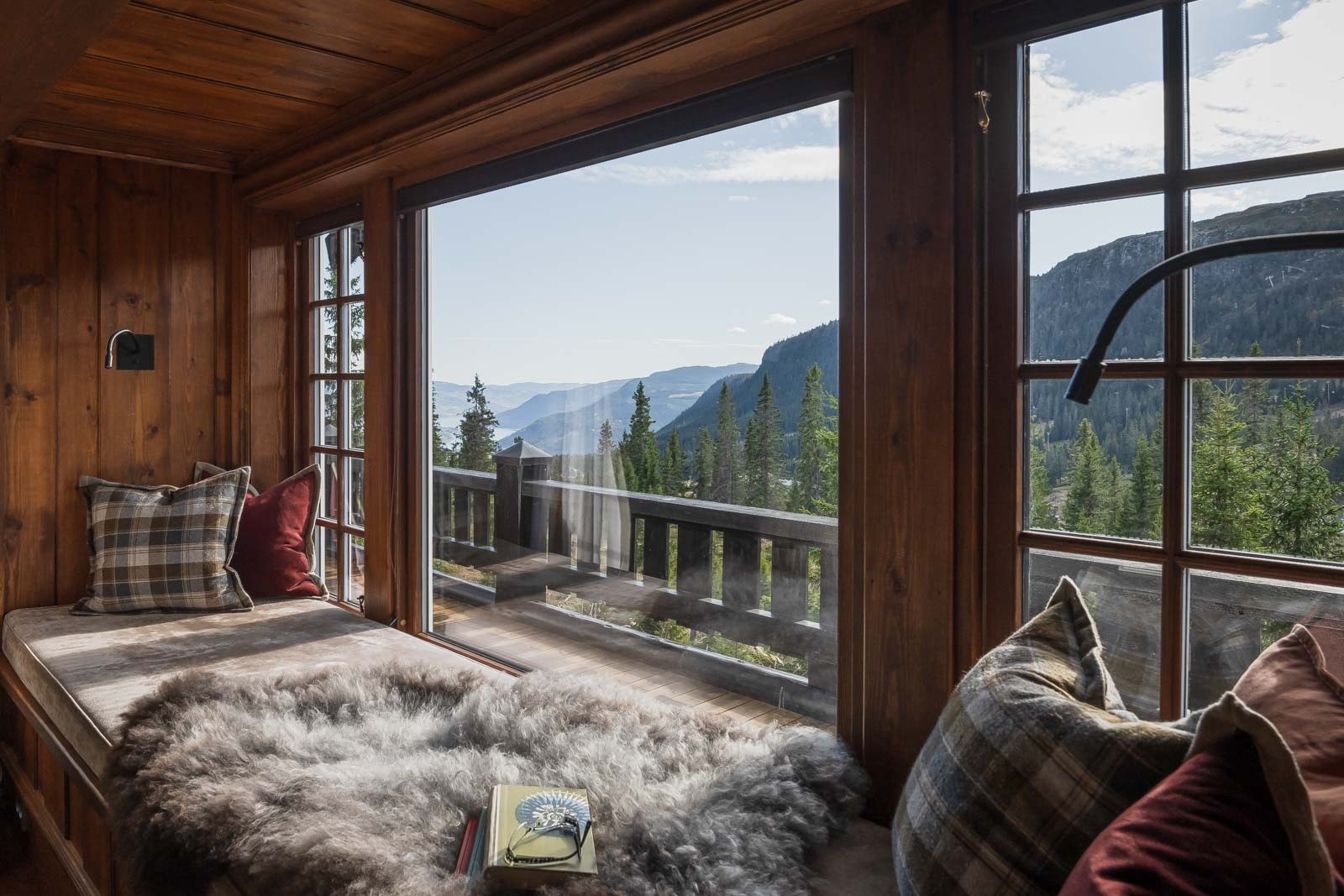 Koselig sitteplass i vinduskarmen, med utsikt mot terrassen og fjellheimen. Galleribilde