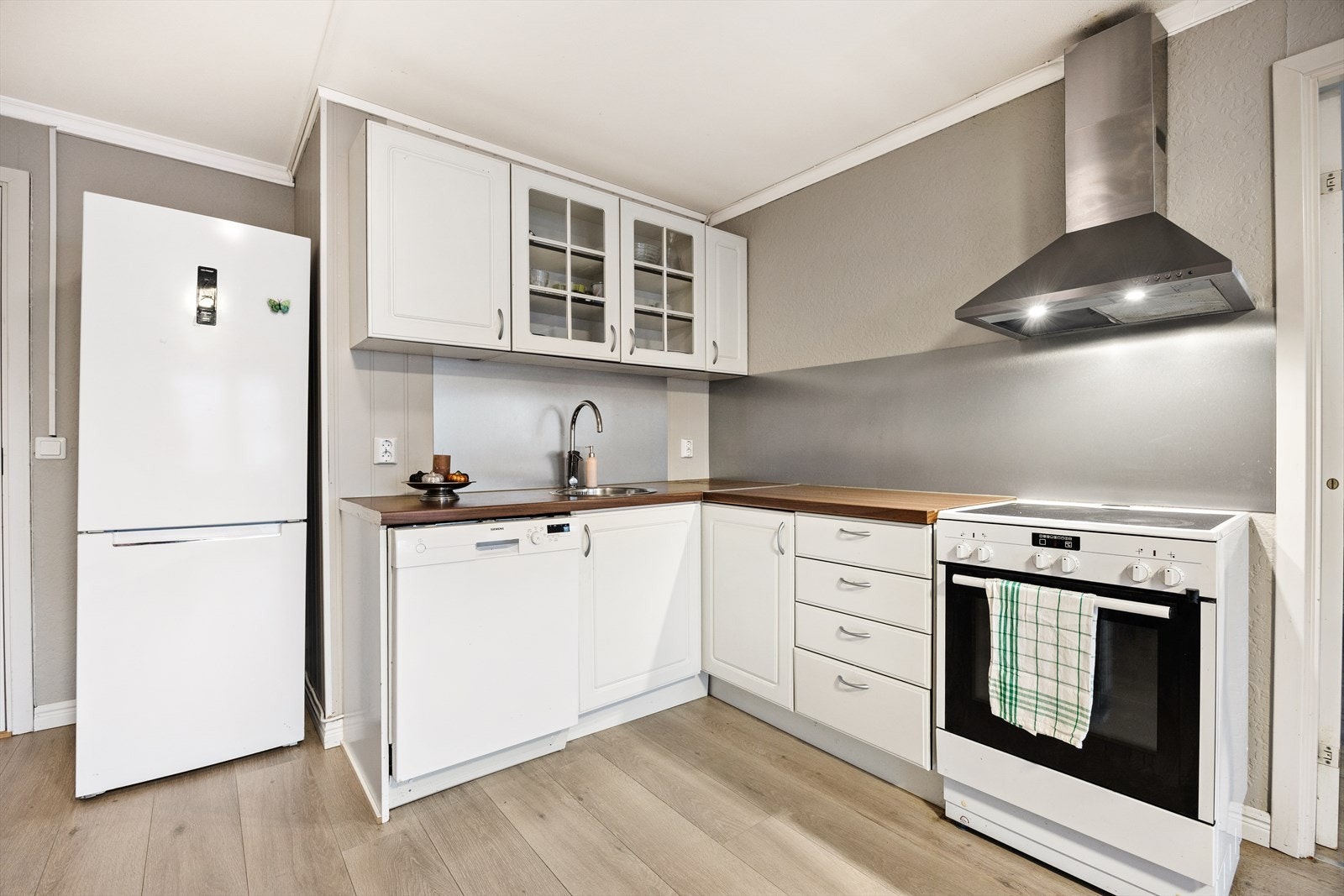 Innredningen har profilerte fronter, vitrineskap og laminerte benkeplater Galleribilde