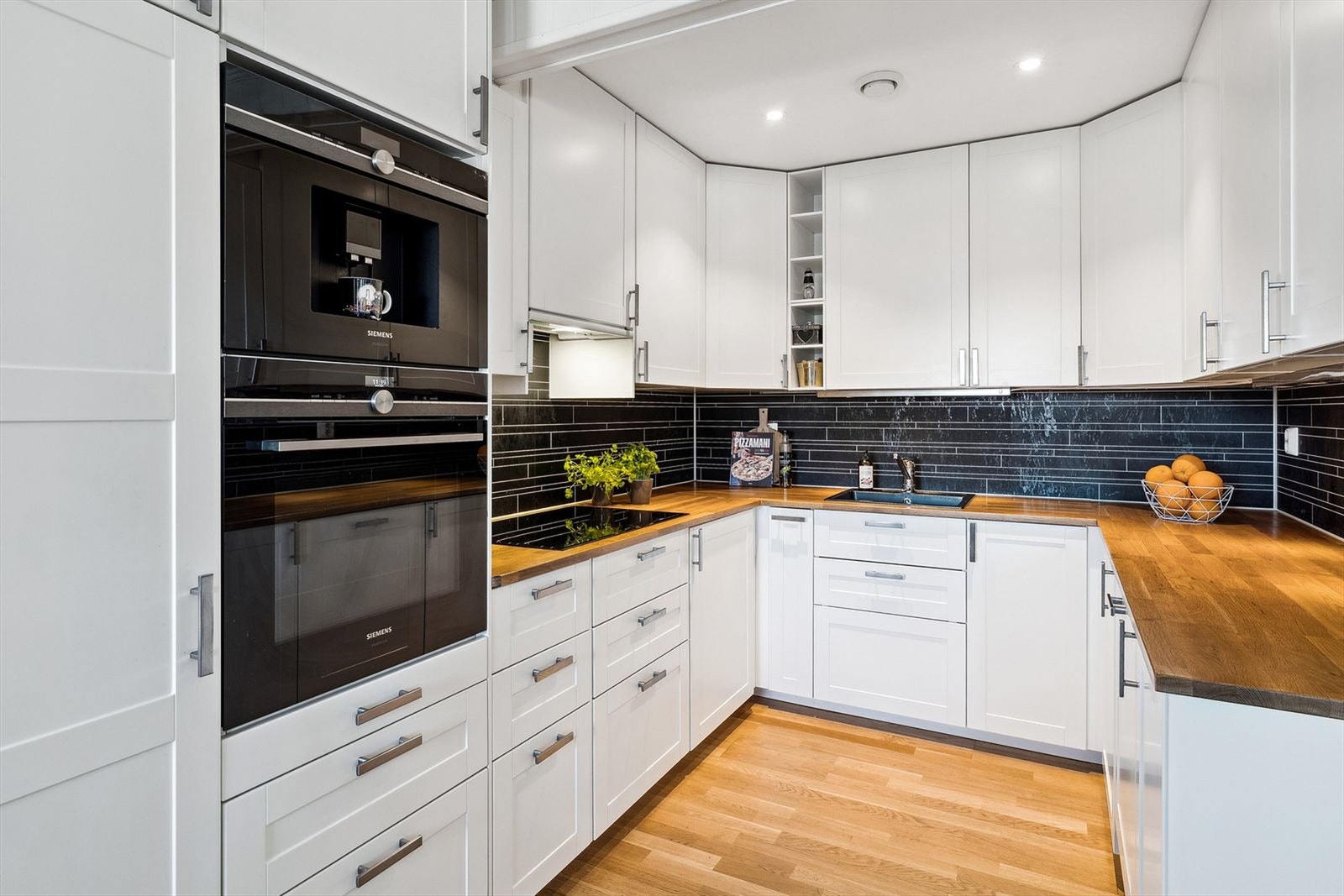 Lyst og praktisk IKEA kjøkken med masse skap/skuffeplass. Integrerte hvitevarer samt kaffemaskin. Galleribilde