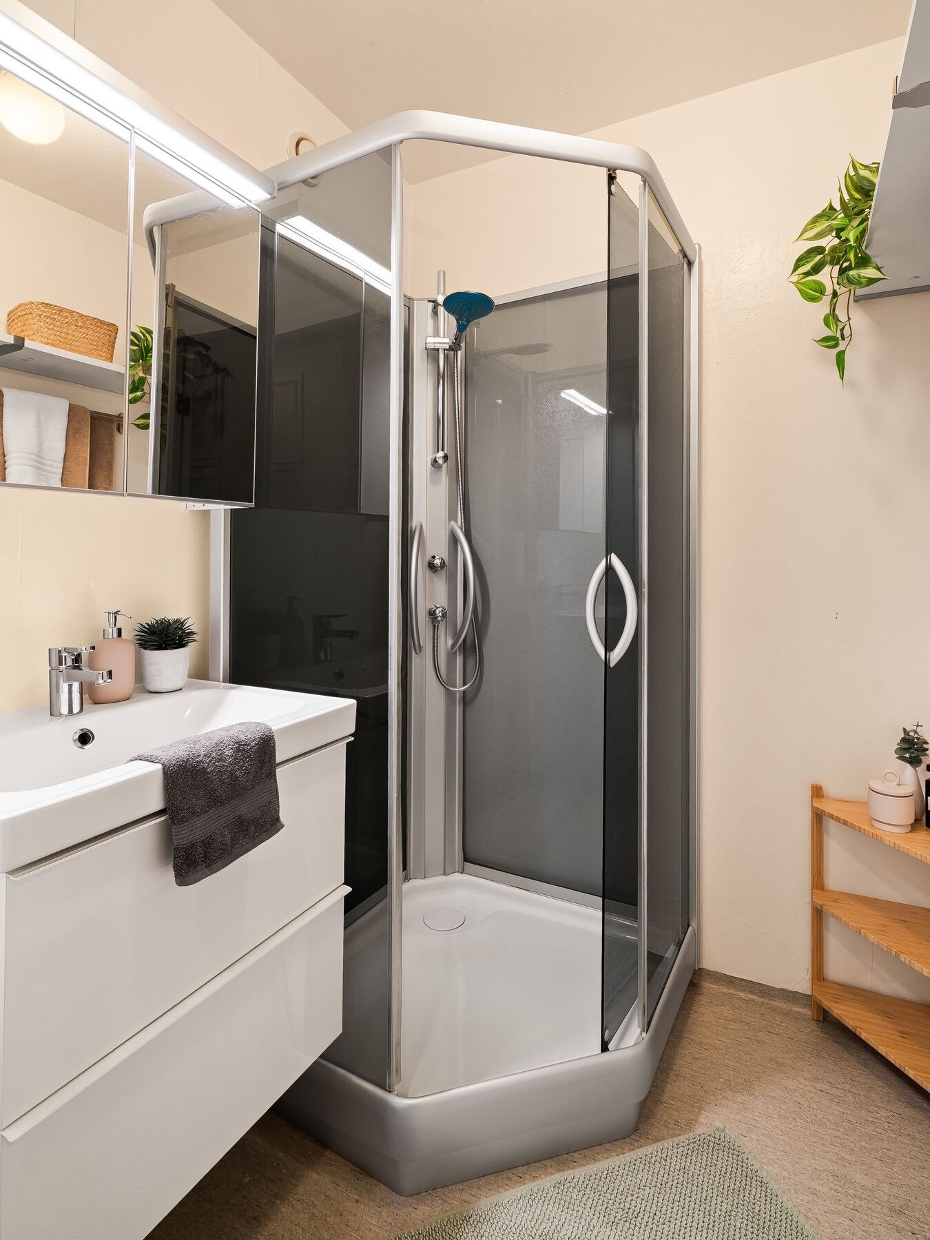 Pent bad med dusjkabinett, servant med underskap og speil. Badet er oversiktlig og lettstelt, med en praktisk løsning for daglig bruk. Galleribilde