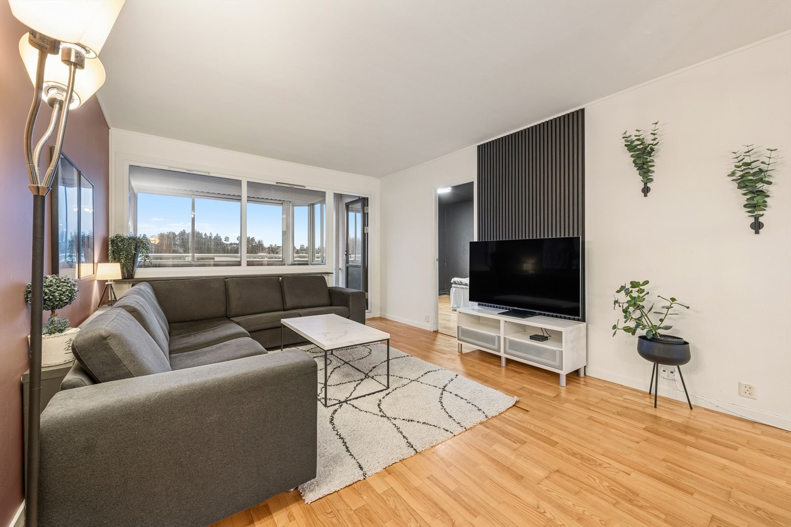 Leiligheten har en lys og innbydende stue som er enkel å møblere. Galleribilde