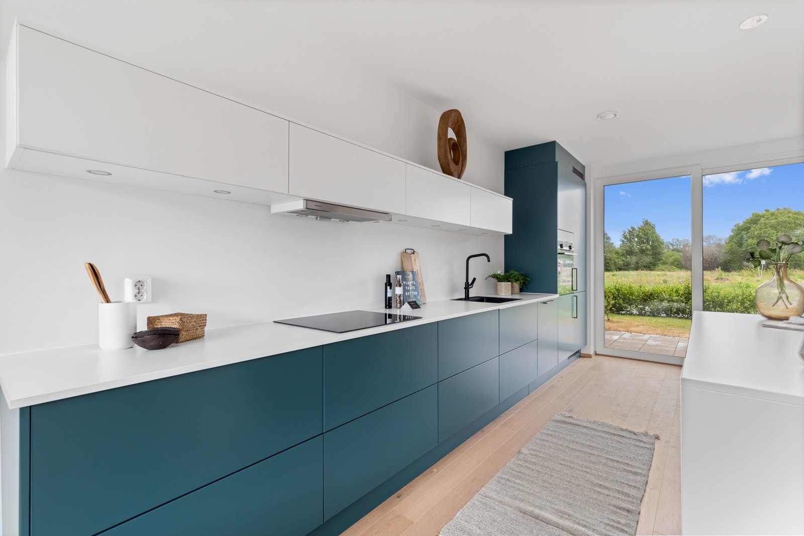 Stue og kjøkken i første etasje utgjør hjemmets naturlige hjerte - gjennomgående og åpent - med god kontakt med uterommene på hver side av huset Galleribilde