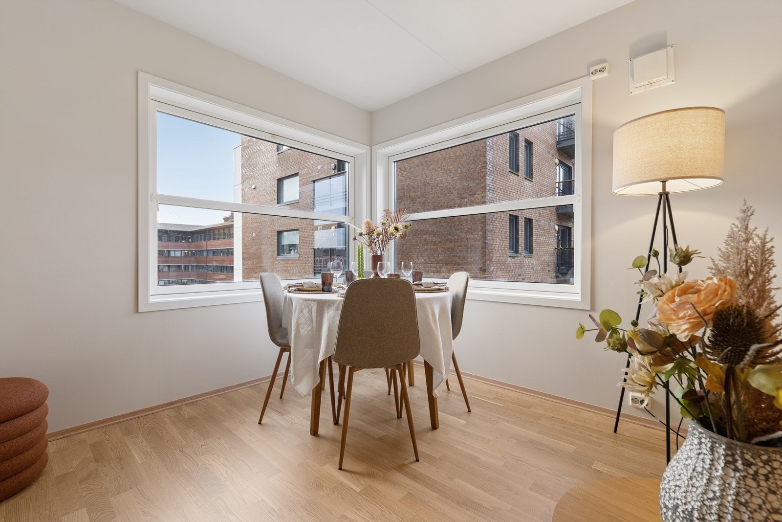 Et lyst og åpent spiseområde der store vinduer og lyse gulv skaper en luftig atmosfære. Galleribilde