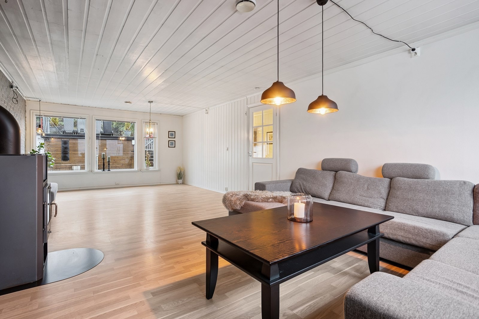 Den romslige stuen har peisovn som gir både varme og kos på kalde dager, og store vinduer som slipper inn rikelig med dagslys. Galleribilde