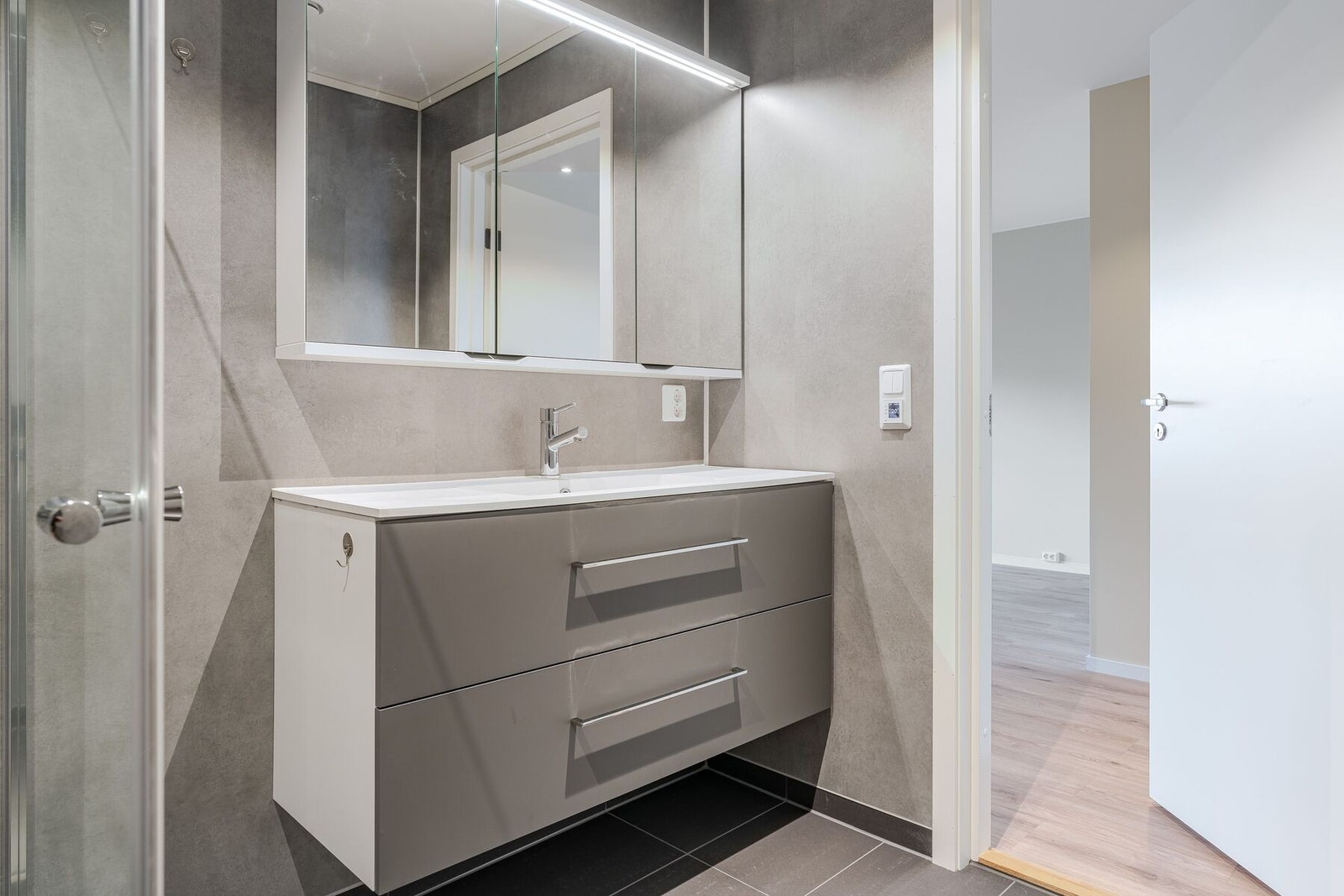 Badet er utstyr med baderomsinnredning, dusjplass og toalett Galleribilde