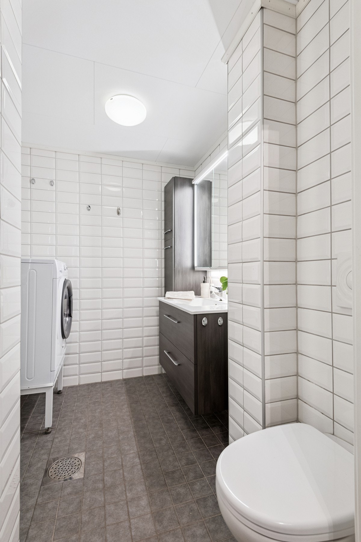 Flislagt bad med vegghengt toalett. Galleribilde