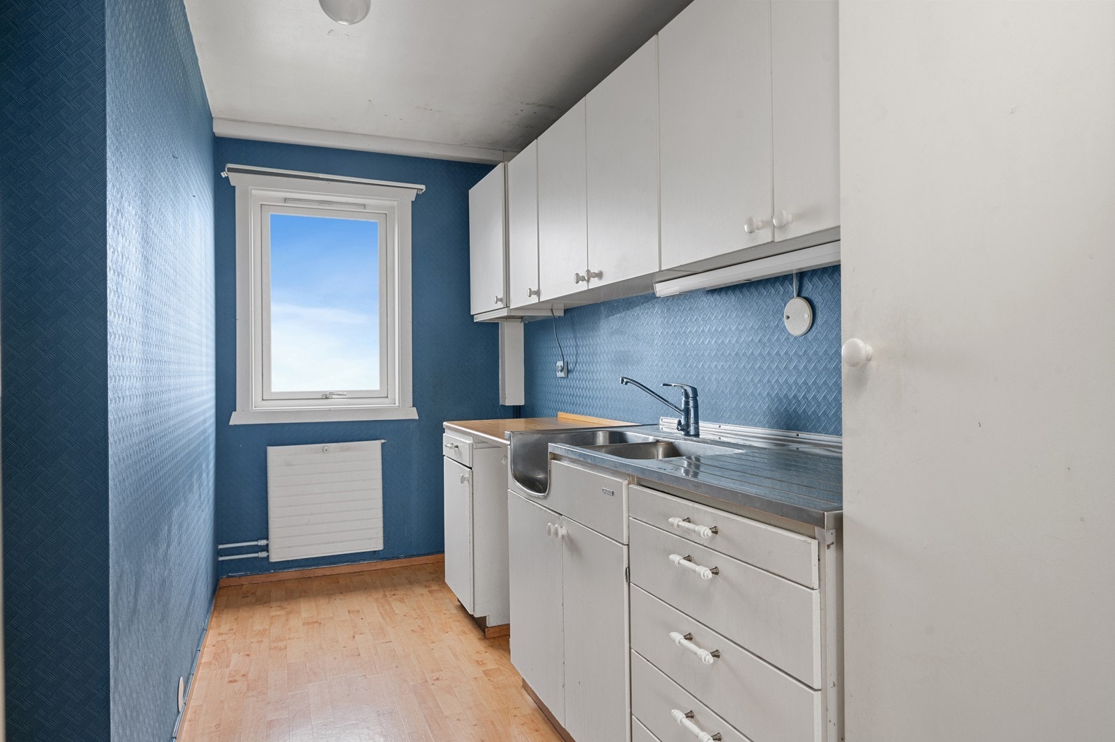 Funksjonelt kjøkken med innredning med slette fronter og ventilator med avtrekk ut. Galleribilde