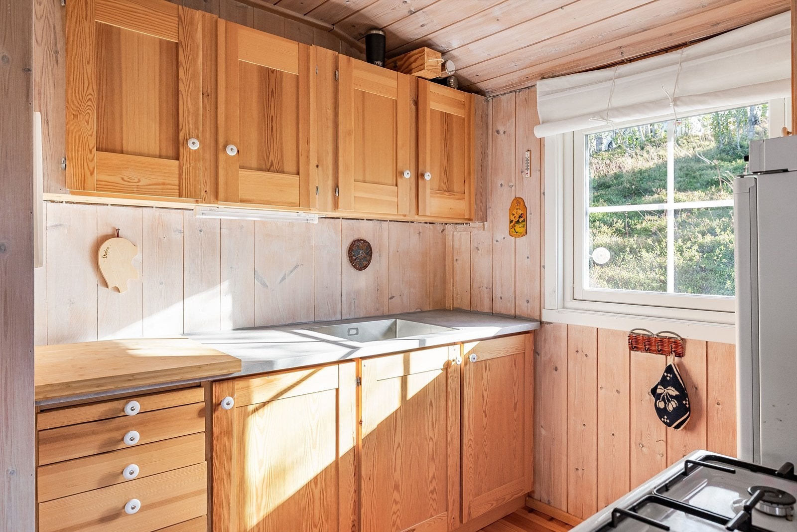 Hytta har et heltre kjøkken med laminerte benkeplater, og komfyr og kjøleskap på gass som medfølger. Galleribilde