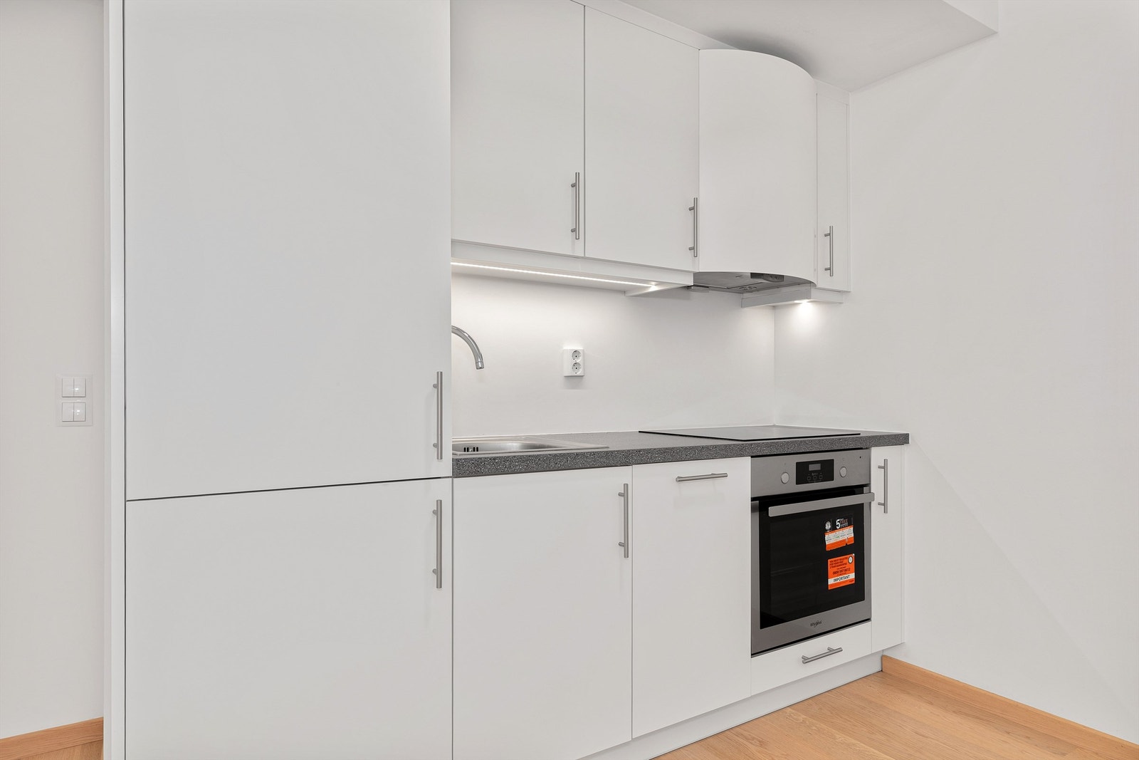 Kjøkkeninnredningen har slette fronter og integrerte hvitevarer fra byggeår. Galleribilde