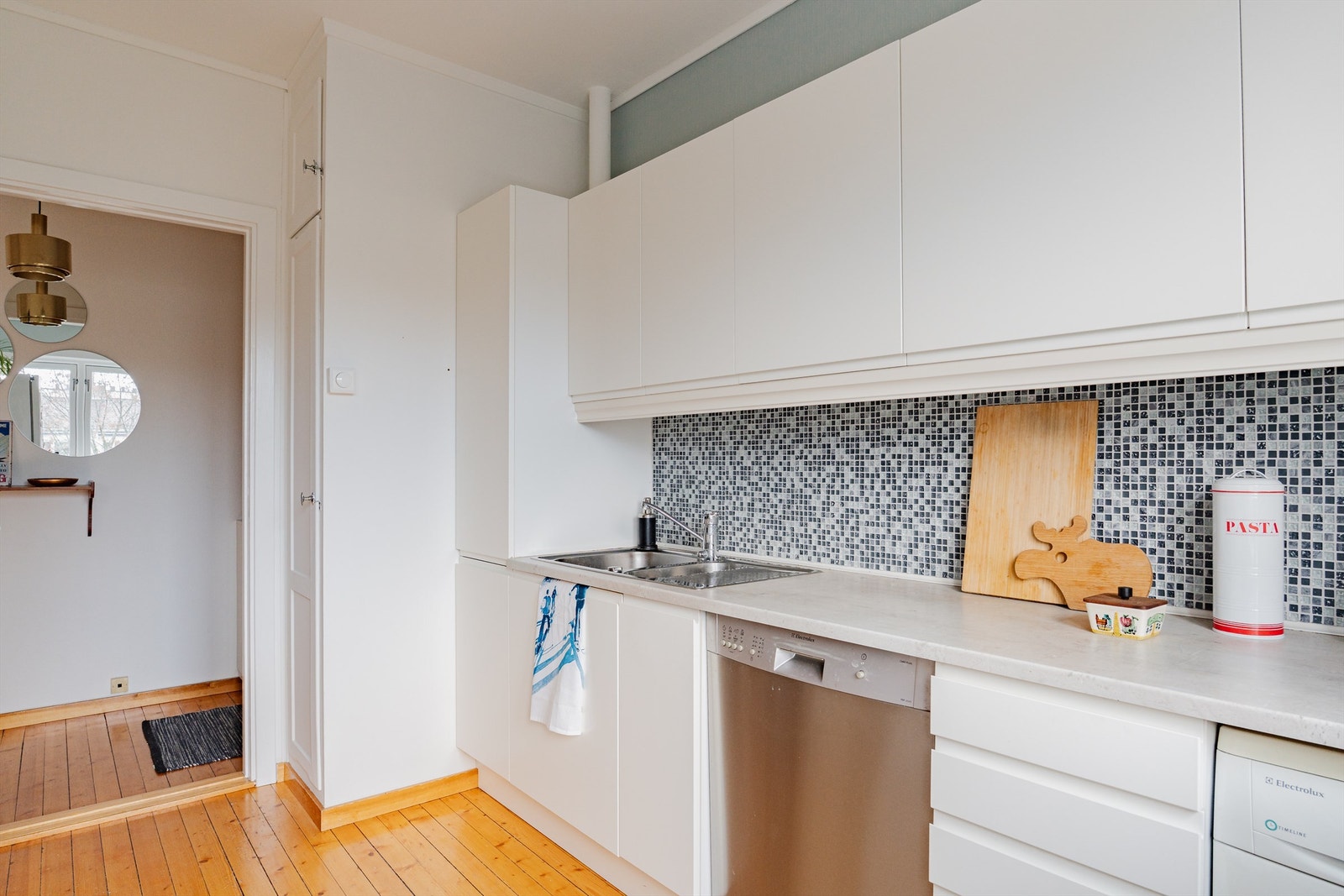 Videre er kjøkkenet innredet med glatte fronter og benkeplate av laminat. Galleribilde