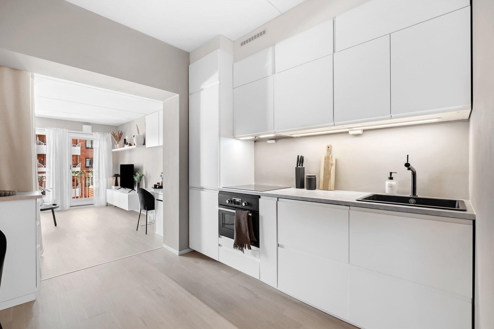 Lys og pen kjøkkeninnredning fra 2021 med god skap- og benkeplass Galleribilde