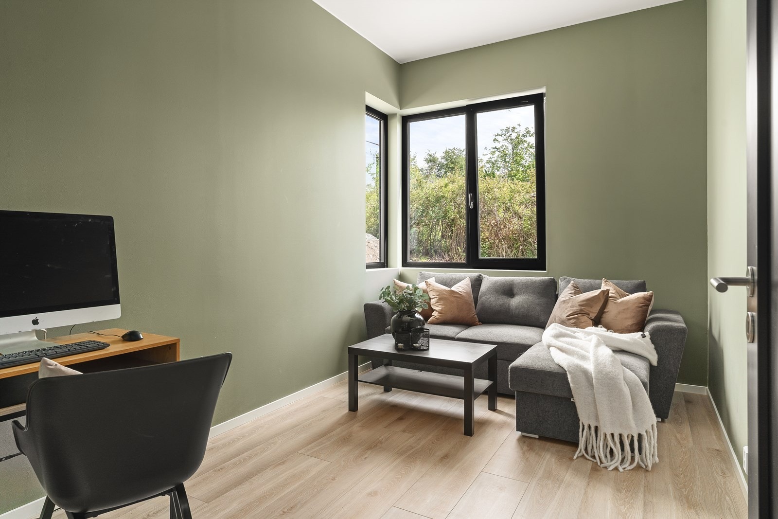 Lyst og moderne soverom med store vinduer som gir flott utsikt til naturen. Her innredet som TV-stue. Galleribilde