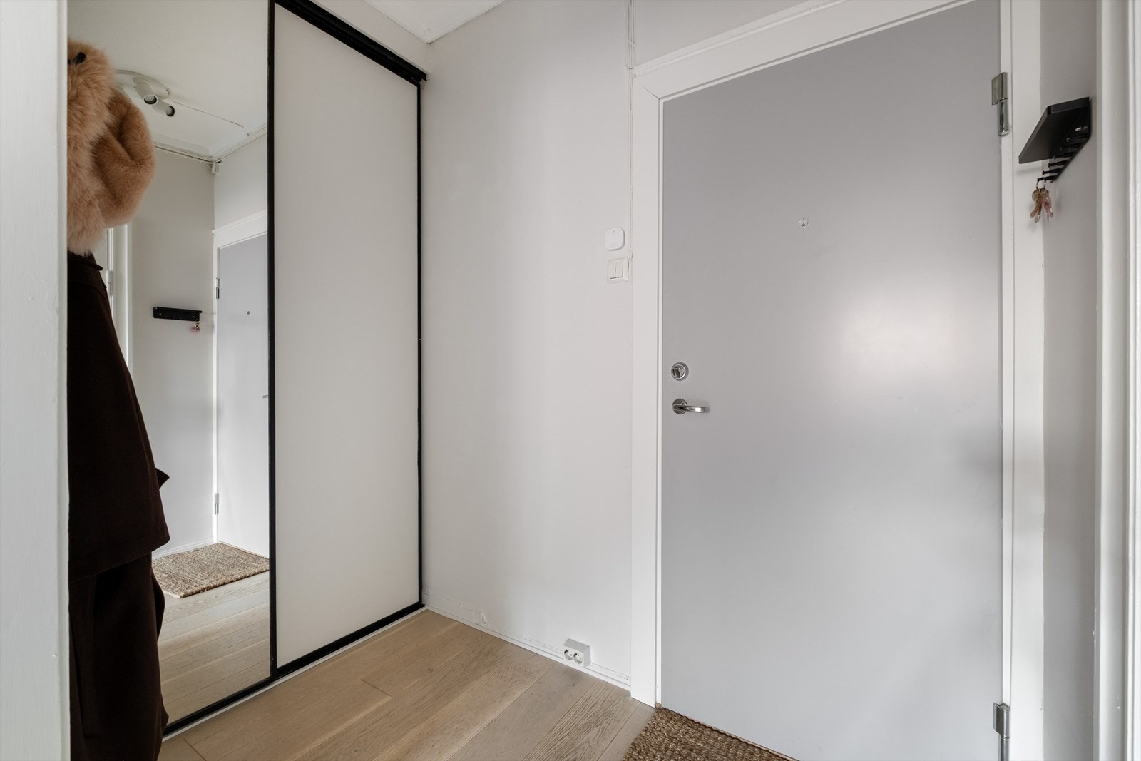 Velkommen inn! En lys og innbydende entré som gir et godt førsteinntrykk av leiligheten. God plass til sko og yttertøy i skyvedørsgarderobe. Galleribilde