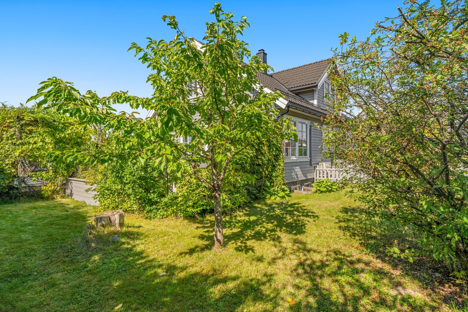 Solrik og pent opparbeidet hage rammer inn eiendommen. Galleribilde