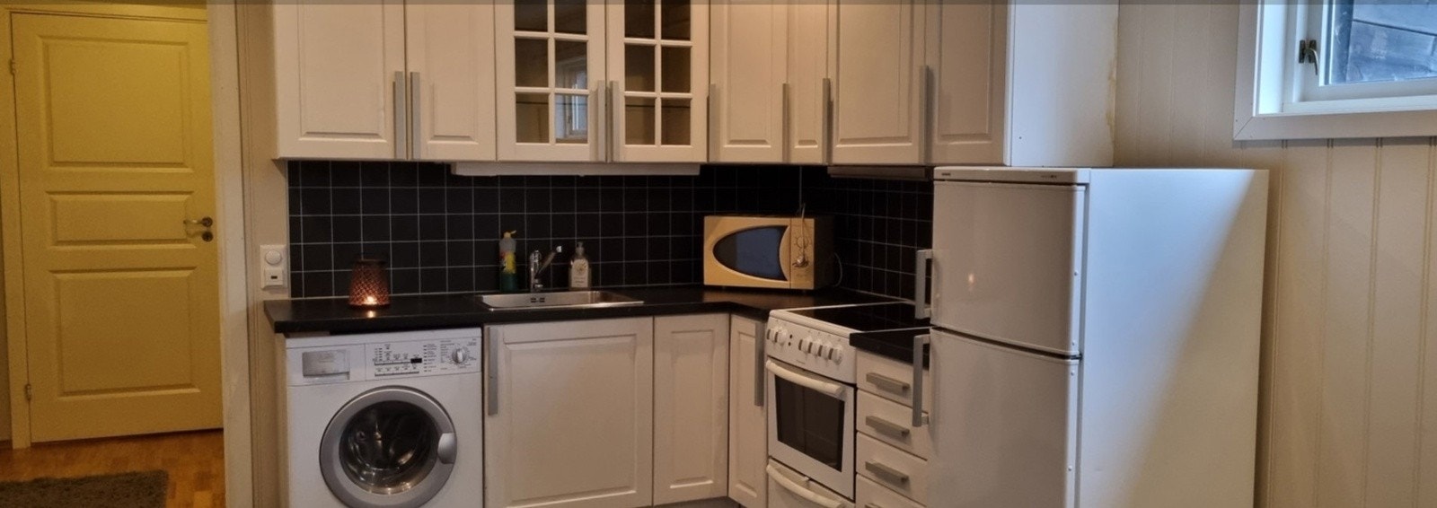 Bilder fra nåværende eier: Kjøkken fra 2009, laminert benkeplate og opplegg til vaskemaskin. Galleribilde