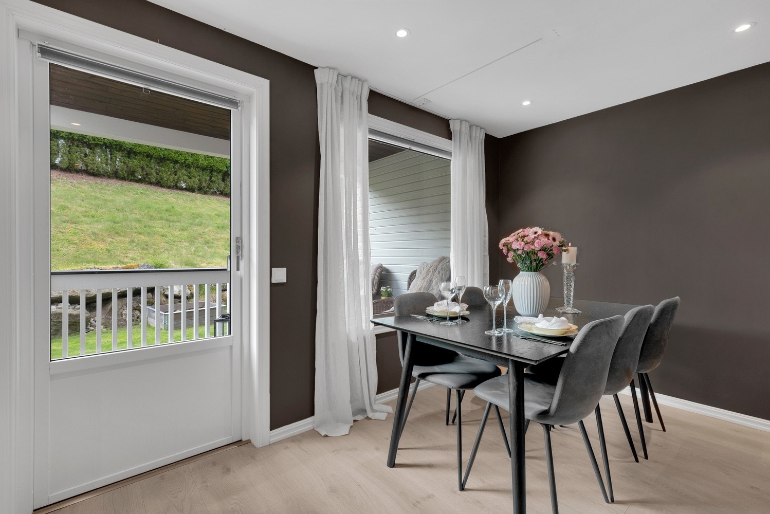 Store vinduer slipper inn naturlig lys og gir deg utsikt til den overbygde terrassen og egen hage. Galleribilde