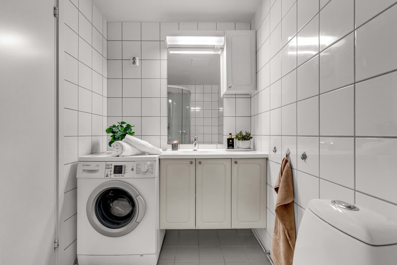 Baderomsinnredningen består av servantskap med nedfelt servant, underskap og 1-greps blandebatteri. I tillegg, finner du dusjkabinett, gulvstående toalett og opplegg for vaskemaskin - en praktisk og funksjonell løsning for daglig bruk. Galleribilde