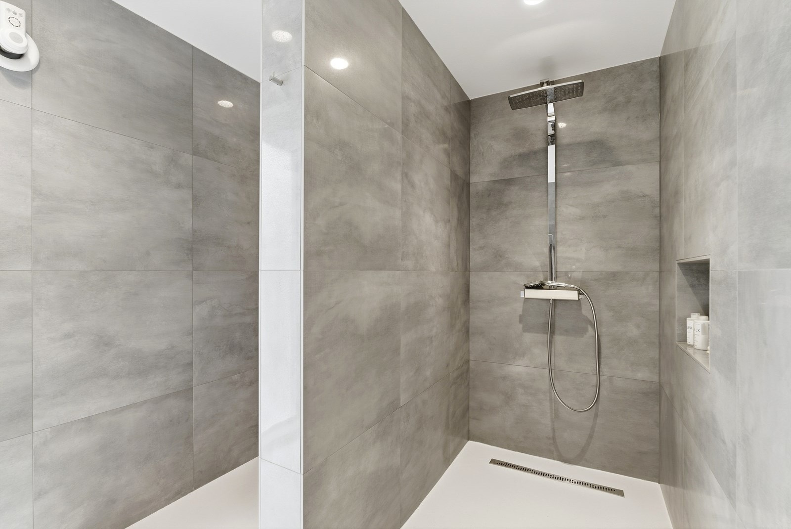 Første sone er en bred dusjnisje med integrert hylle og regndusj. Galleribilde