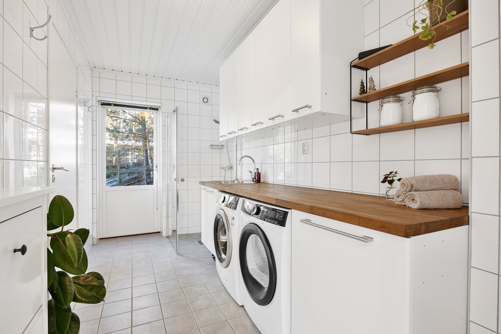 Et separat og romslig vaskerom med dusjhjørne, rikelig med skapplass og egen utgang. Galleribilde