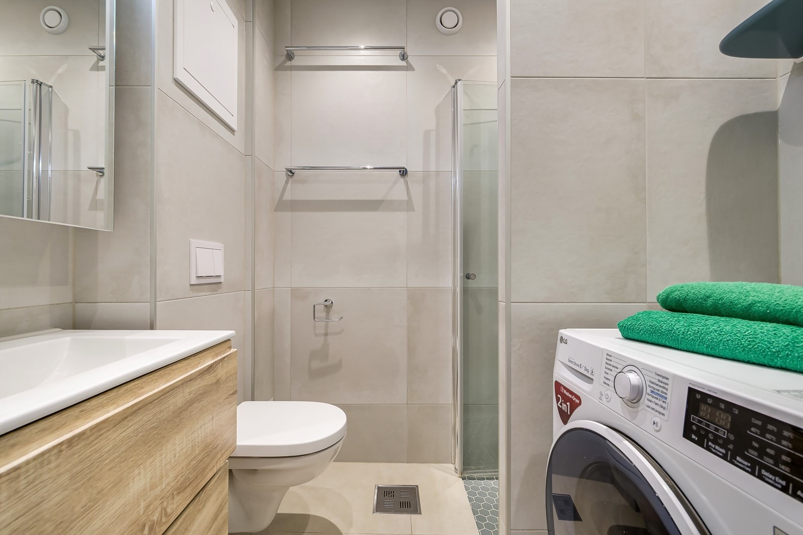 Badet er innredet med servant, dusjsone, vegghengt toalett og opplegg for vaskemaskin. Galleribilde