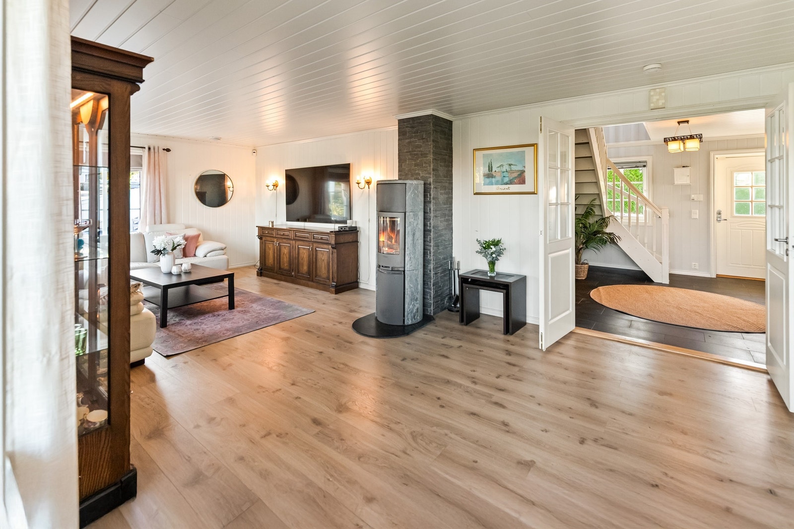 Romslig og lys stue med peisovn. Galleribilde