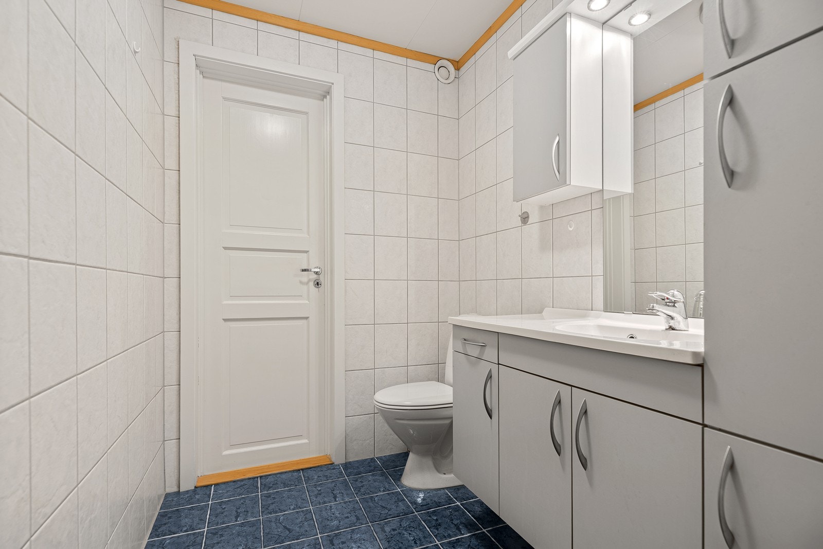 Badet har flislagte overflater og varmekabler i gulv. Rommet har innredning med nedfelt servant, toalett og dusjkabinett Galleribilde