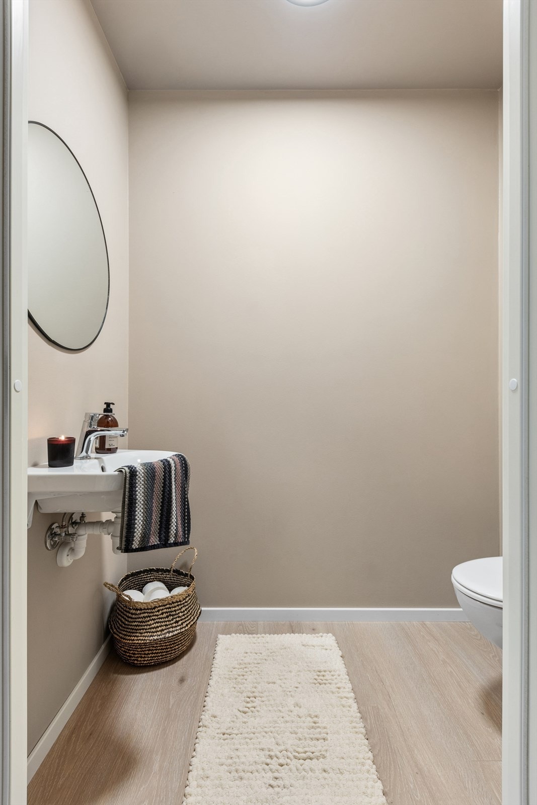 Gjestetoalettet er innredet med et vegghengt toalett og vegghengt servant. Galleribilde