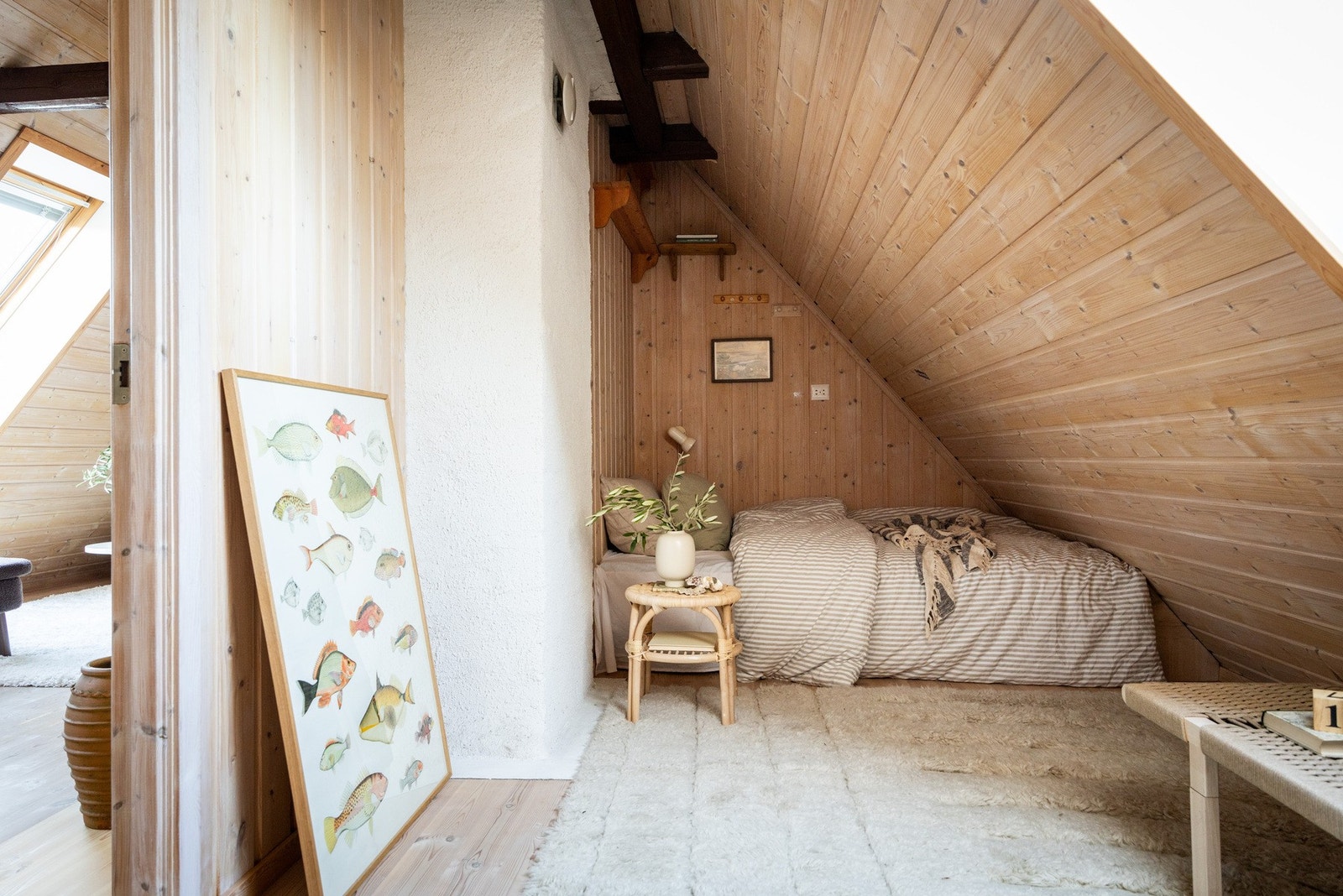 Soverommet i andre etasje har en sjarmerende loftsfølelse med skråtak og gjennomgående trepanel som gir rommet et varmt og koselig uttrykk. Galleribilde