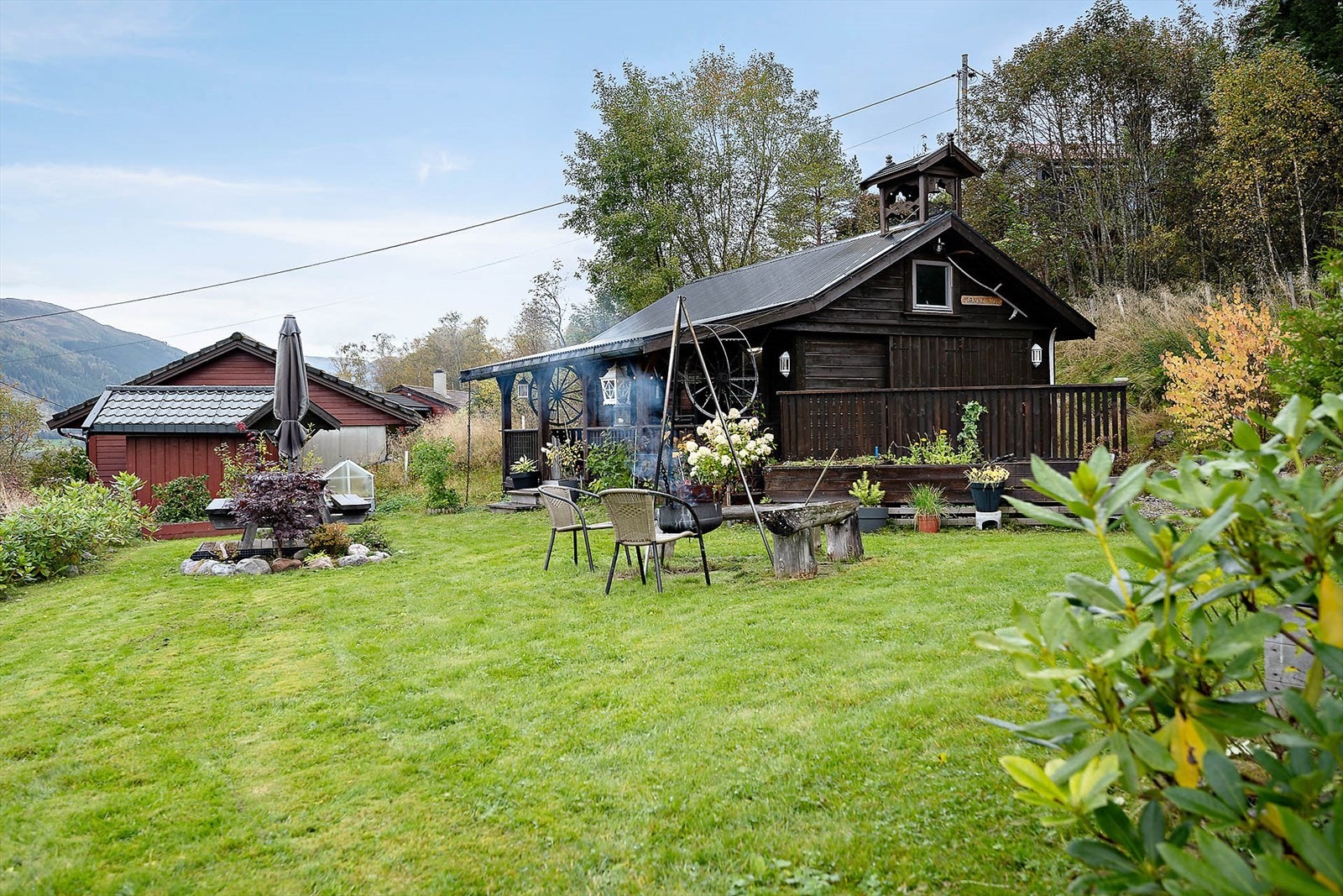 Hytten ligger på en høyde i nordvestvendt terreng med utsikt til Jølstravatnet og fjellene rundt. Galleribilde