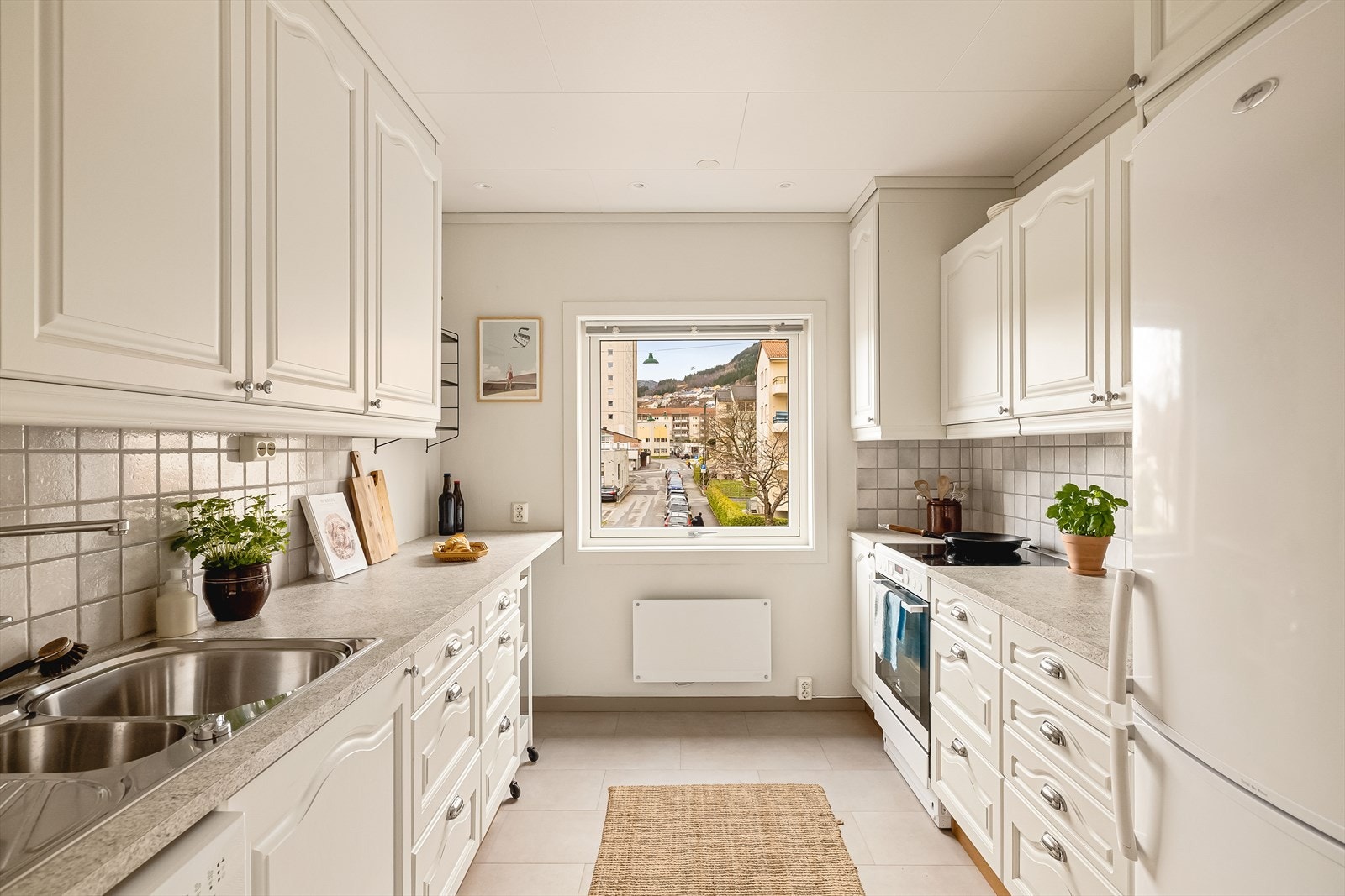 Leiligheten har et romslig og adskilt kjøkken som måler 8,1 kvm. Her ble det montert ny Pergo klikkvinyl i 2020. Alle hvitevarer på kjøkken følger med. Galleribilde