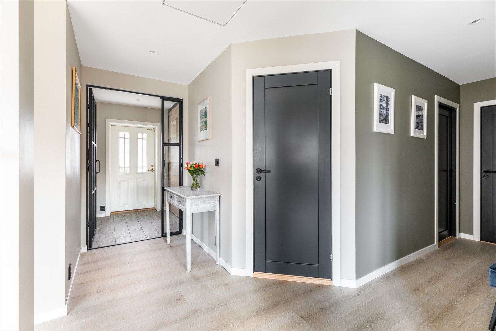 Entreen kan lukkes av mot hallen med glassdør i samme industrielle preg som det innfelte vinduet mot stuen. Galleribilde