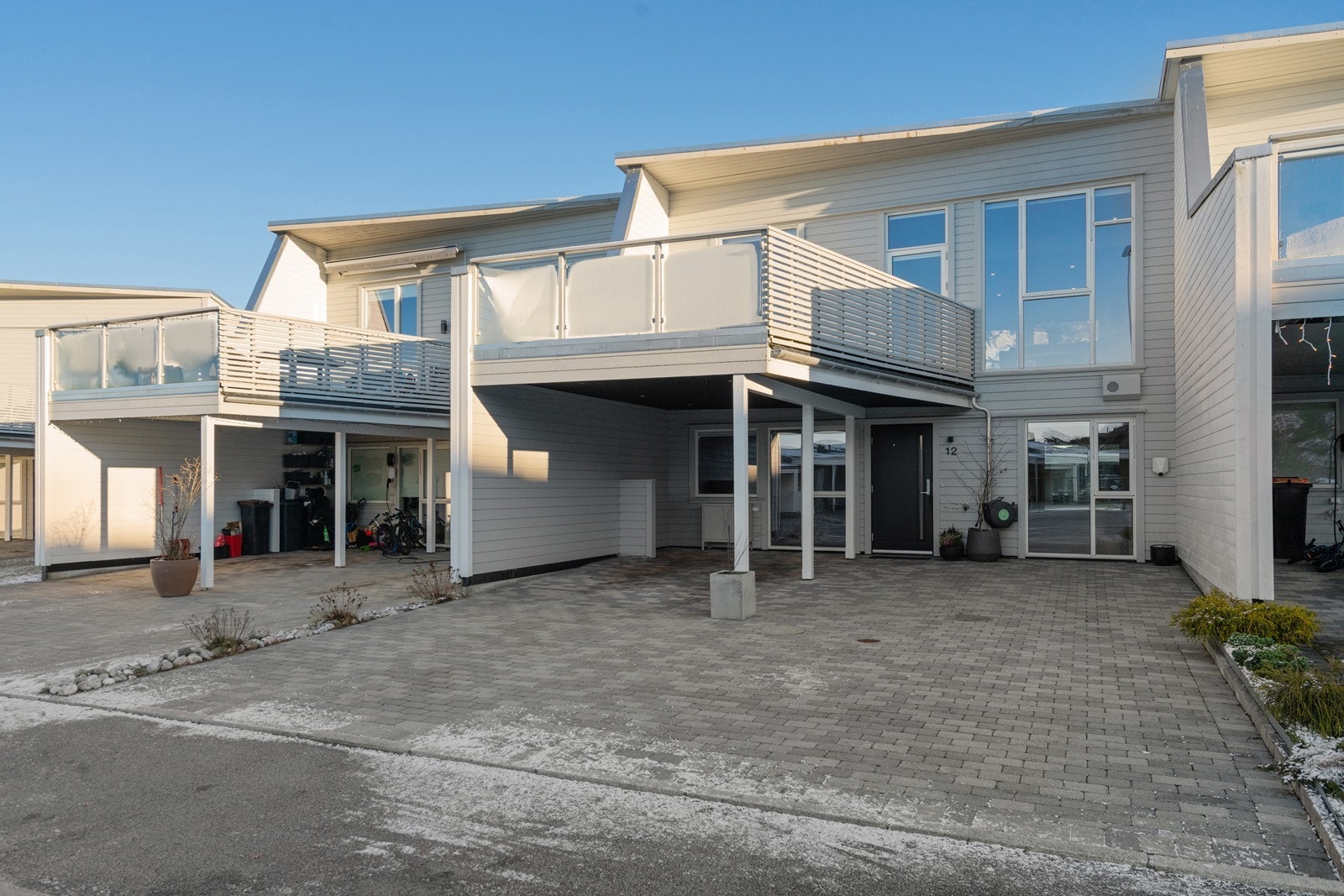 Velkommen til Lonasvingen 12. Innbydende rekkehus med carport og stort gårdsrom med belegningsstein. (Fotograf: Hanne Karlsen) Galleribilde
